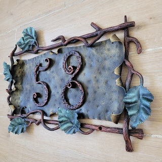 Full plaque displayed outdoors, mounted on light stone wall.