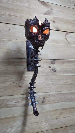 Full view of gothic wall-mounted torch lamp with vertebra-style handle
