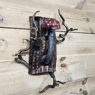 Full fireplace tool set mounted on tree-trunk shaped wall holder with twisting branches
