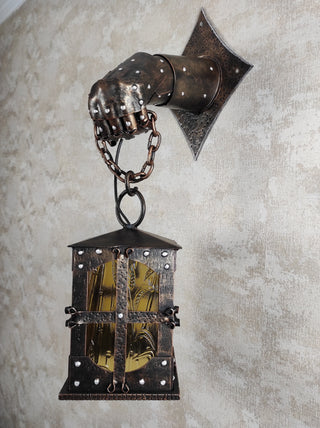 Wrought iron wall lamp on a metal knight's hand. Wall lantern, Ceiling lantern, Wrought iron sconces, lantern centerpiece, Medieval lantern