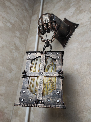 Wrought iron wall lamp on a metal knight's hand. Wall lantern, Ceiling lantern, Wrought iron sconces, lantern centerpiece, Medieval lantern