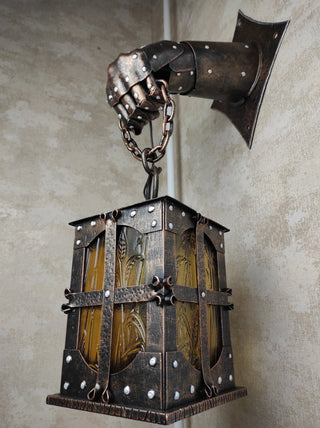 Wrought iron wall lamp on a metal knight's hand. Wall lantern, Ceiling lantern, Wrought iron sconces, lantern centerpiece, Medieval lantern