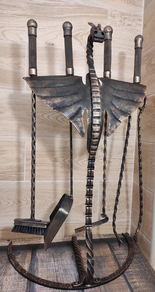 Fireplace tools. Set from forged fire poker, fire tongs, fire shovel, fire broom on dragon wings