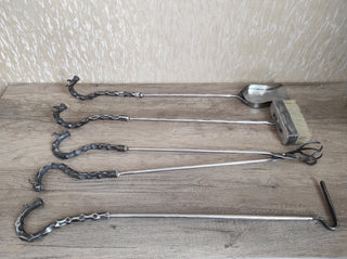 Fireplace tools. Set from forged fire poker, fireplace tongs, shovel, broom, hand forged