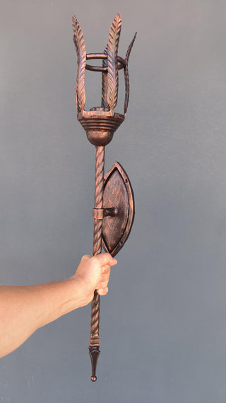 Metal wrought iron sconce for indoor use, made in a medieval style in copper color