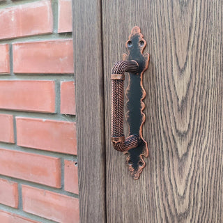 Medieval style forged metal door handle in copper color