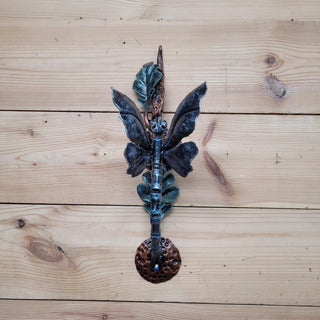 Rustic wrought iron door pull with nature-inspired design