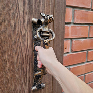 Unique metal dog door pull with detailed sculpting, ideal for gates, wooden doors, and themed interiors.