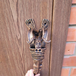 Decorative metal door pull with bull face and curled horns