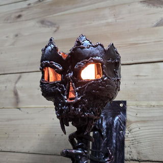 Artistic welded skull with glowing eyes as dark fantasy decor