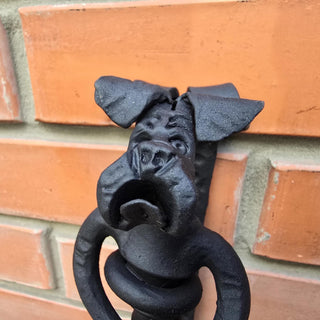 Dog head detail showing expressive facial features in forged iron.