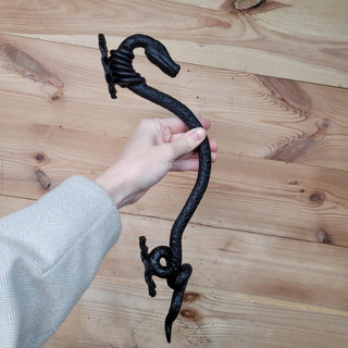 Serpent-themed iron door pull for indoor and outdoor use
