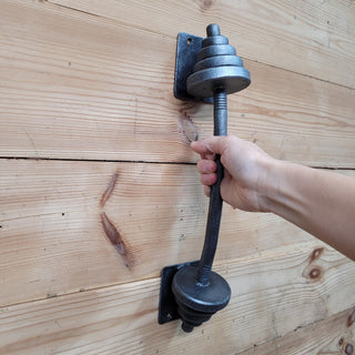 Iron dumbbell door handle with decorative finish, perfect for gym rooms, gates, and barn-style doors.