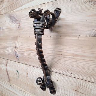 Side view of artistic iron door handle shaped like a bull