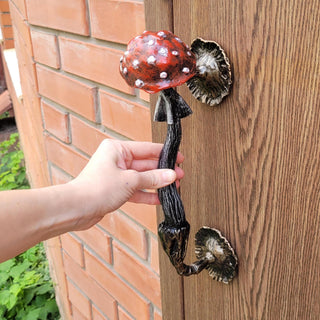 Made from solid wrought iron and hand-painted with a red cap and white spots, this whimsical piece is inspired by the iconic toadstool mushroom. Perfect for fairycore, cottagecore, forest, or rustic-style interiors and exteriors